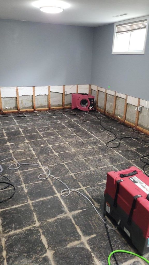 A work in progress photo of the room affected by a sewage backup