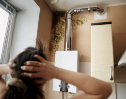 a woman finds mould growth in her home