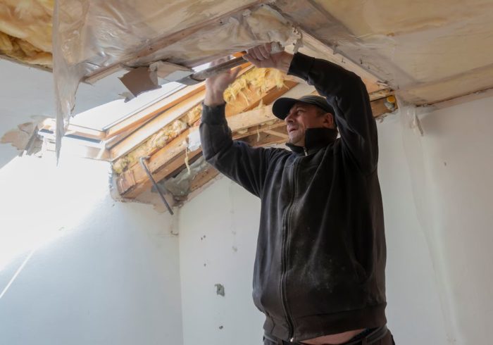A worker from a restoration company in chatham-kent works to restore water damage in a building
