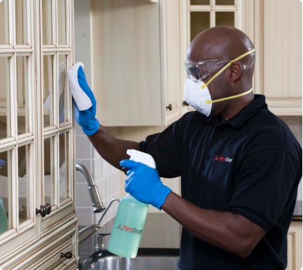 Man cleaning closet with a mask