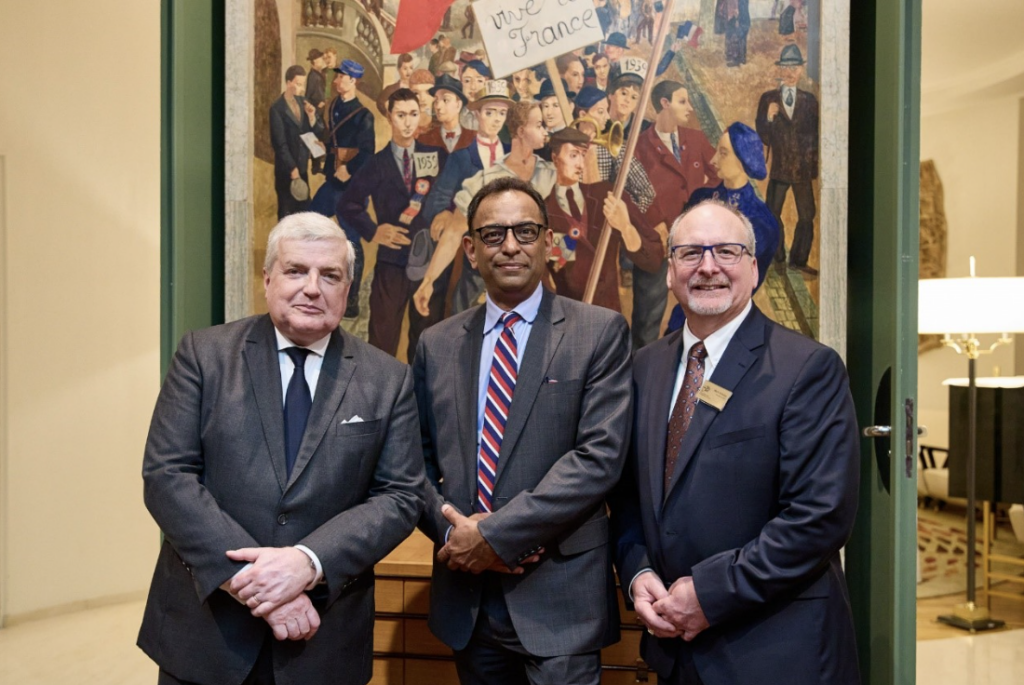 three men smiling at the camera