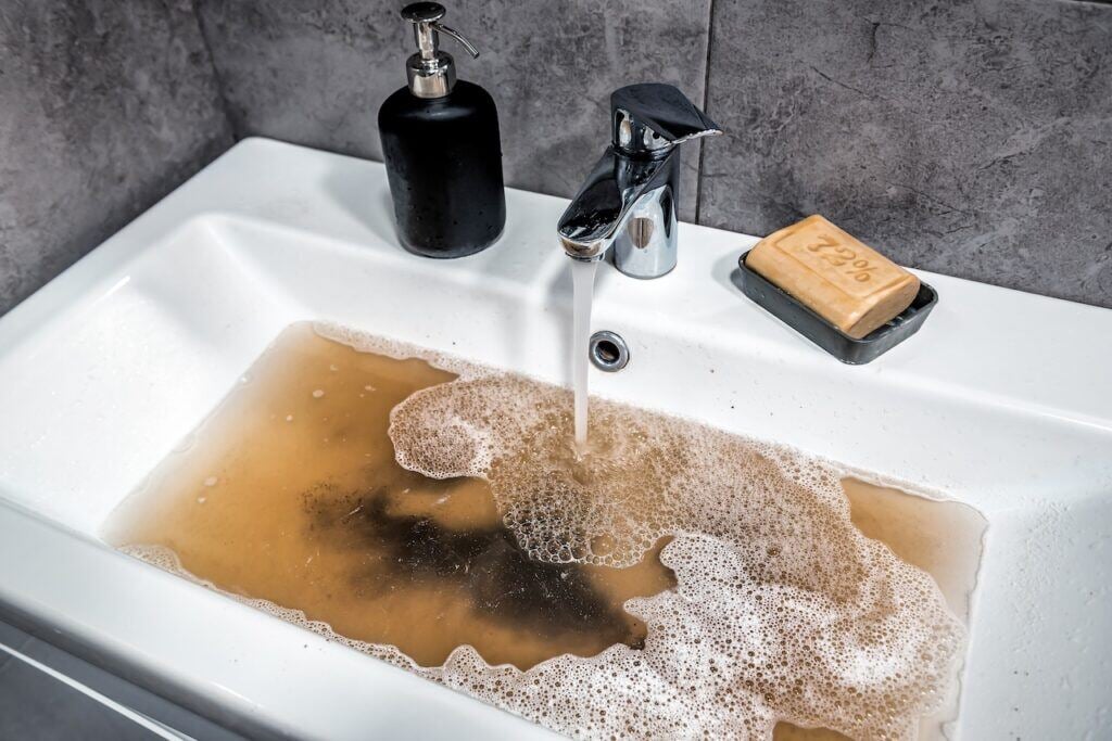 A clogged drain is a sign of sewage backup.