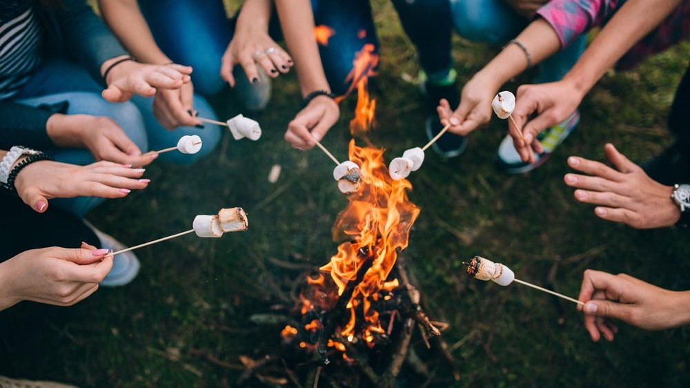 roasting marshmallows at a campfire