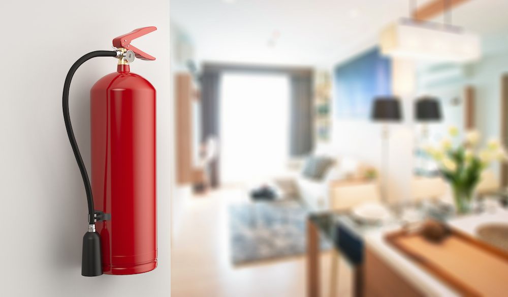 A red fire extinguisher on the wall of a living room