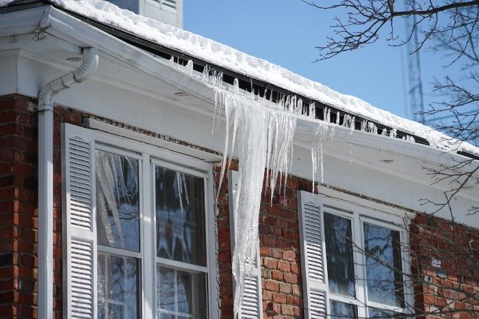 A gutter being weighed down by icicles